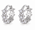 Pair of silver Allstar Huggie earrings on a white background