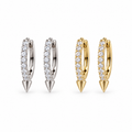 Diamond Spike huggie earrings in silver and gold on a white background